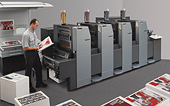 Heidleberg Anicolour Heidleberg Anicolour pic of printing press man holding sheet of paper